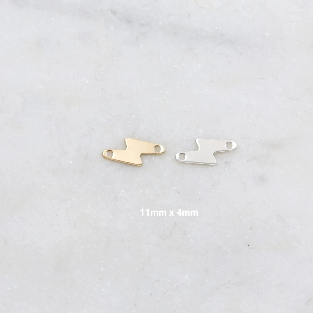 Gold and silver shoe-shaped charms on a light gray background
