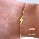 Gold lightning bolt bracelet connector on a wrist with product details.