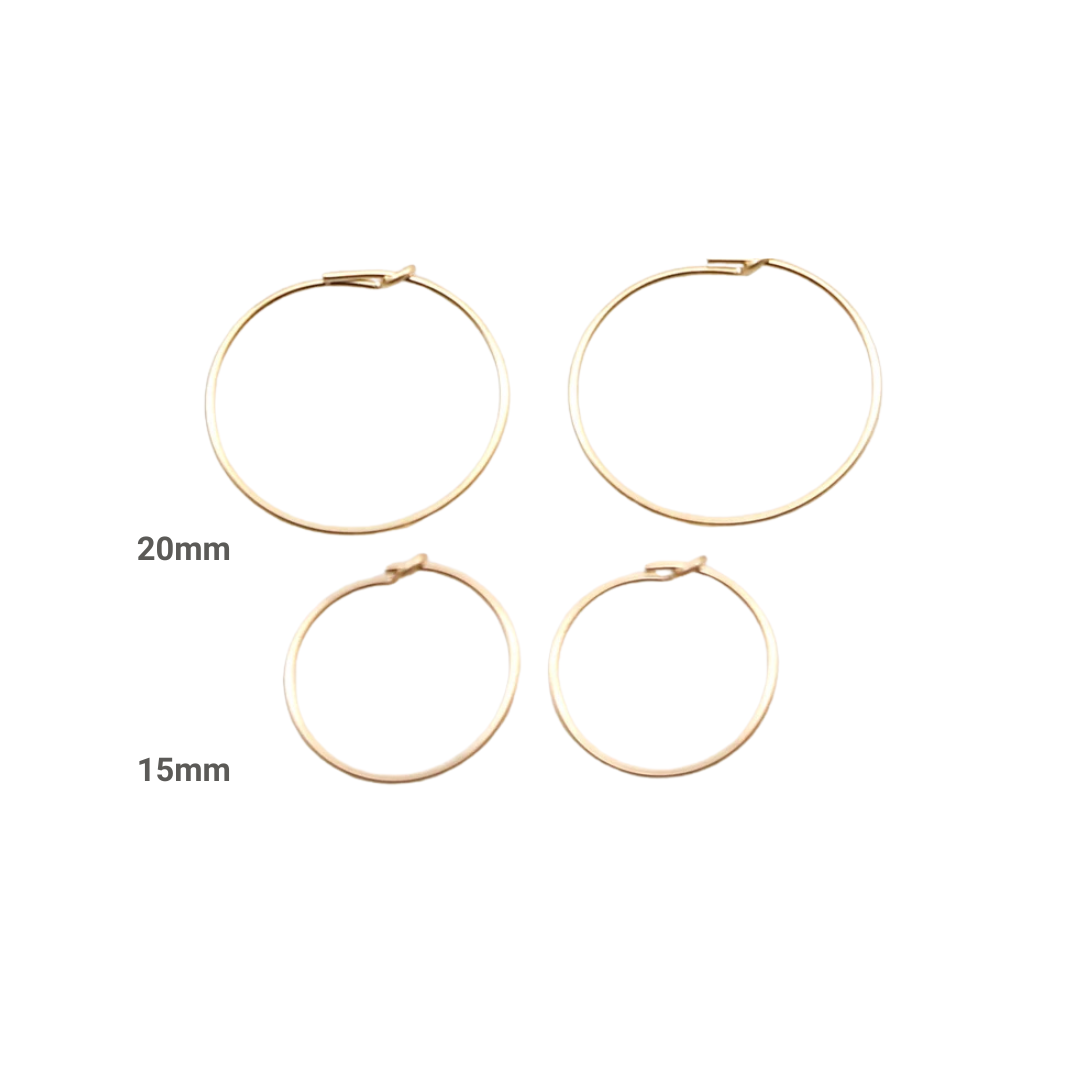 Set of gold hoop earrings with size labels on a white background