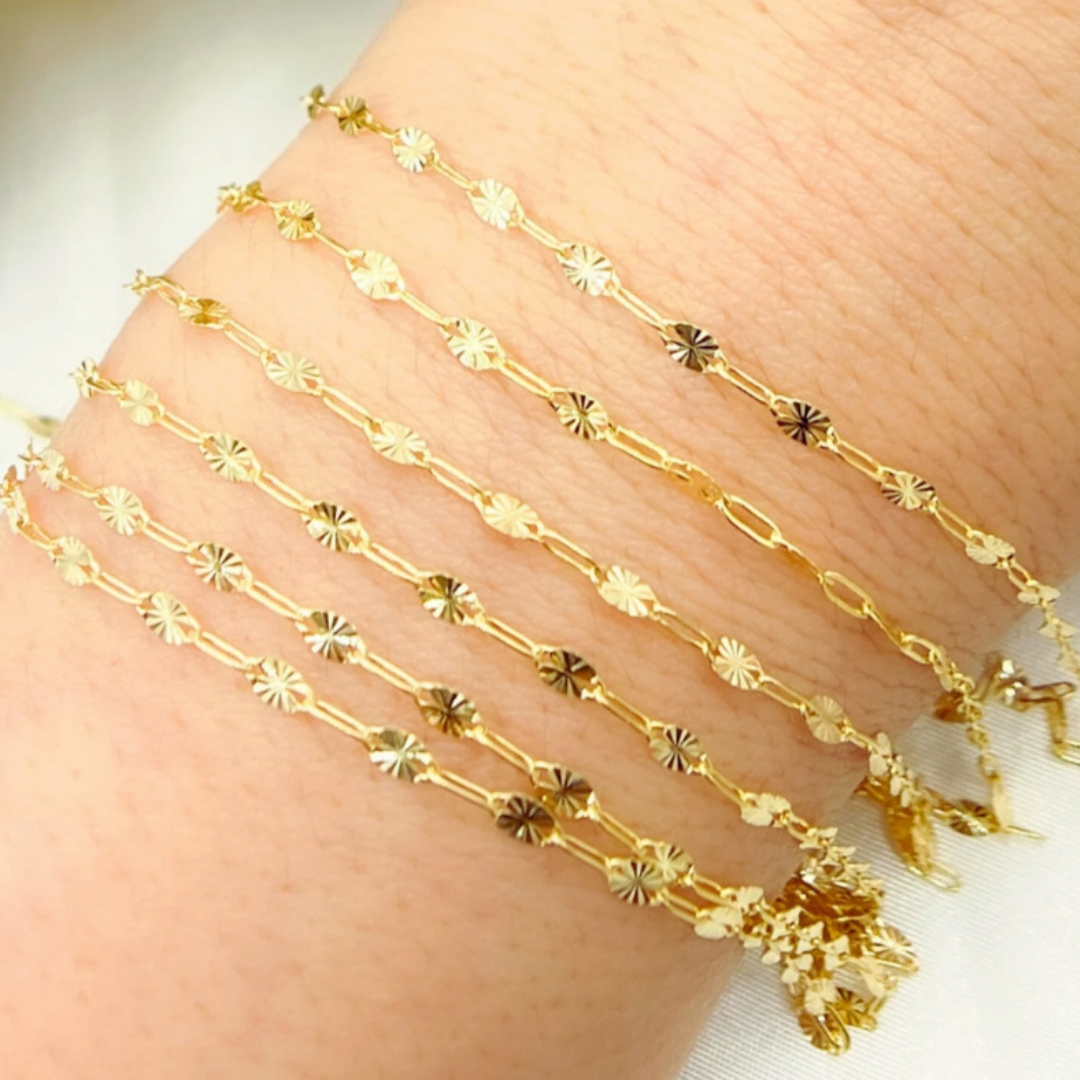 Stack of chains wrapped on wrist for permanent jewelry company